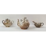 Chinese sterling white metal three-piece tea service, viz:- teapot with swing handle, dragon's