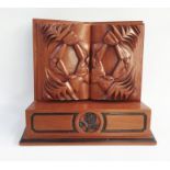 Carved wooden presentation stand with a carved open book, 38cm side x 30cm high