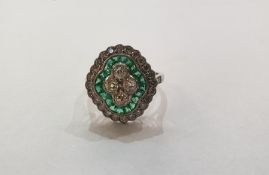 Victorian style, platinum, emerald and diamond ring set four diamonds to the centre surrounded by