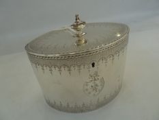 George III silver neoclassical oval tea caddy, with urn shaped finial, garland engraved borders, the