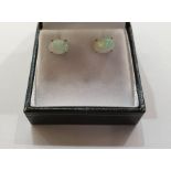 Pair of white metal Ethiopian opal stud earrings, each with oval cabochon stone