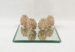 Square mirrored base with four fir cone candleholders