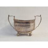 Silver sugar bowl of rectangular form ,with twin handles, raised on ball feet, Sheffield 1917,