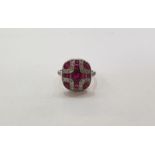 Platinum Art Deco style, ruby and diamond ring, rounded rectangular, set with oval ruby and