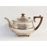 Silver teapot of plain form, with gadrooned border, raised on ball feet, London 1918, length 28cm,