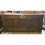 18th century oak coffer, the three-panelled top with moulded stiles, lunette carved front, with