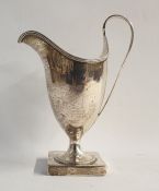 George III silver creamer of helmet-shaped form, reeded rim and handle, raised on square footed
