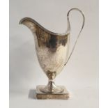 George III silver creamer of helmet-shaped form, reeded rim and handle, raised on square footed