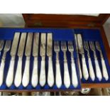 Mother-of-pearl handled fruit knives with silver-plated and engraved forks and knives, place setting
