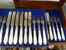 Mother-of-pearl handled fruit knives with silver-plated and engraved forks and knives, place setting