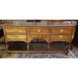 George III oak dresser base, the rectangular top above five assorted drawers, raised on turned