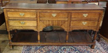 George III oak dresser base, the rectangular top above five assorted drawers, raised on turned