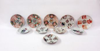 Ten variously sized Asian porcelain small plates, floral and emblem decorated (10)