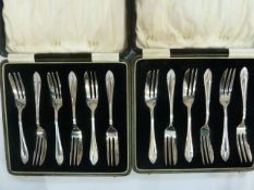 Two sets of six silver cake forks, wheatear pattern, each cased, Birmingham 1928
