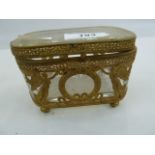 French gilt metal and glass casket, rounded rectangular, with pierced borders, applied with