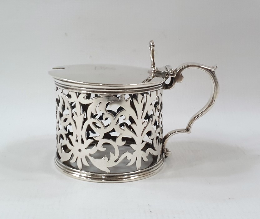 Victorian silver mustard pot with pierced thumbpiece to the scroll handle, the sides foliate