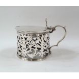 Victorian silver mustard pot with pierced thumbpiece to the scroll handle, the sides foliate