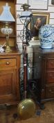 20th century floor-standing oil lamp converted to electricity, on wrought metal stand and a brass