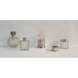 Silver-topped scent bottle with cut glass ovoid body, scrolling foliate lid, a silver engine-