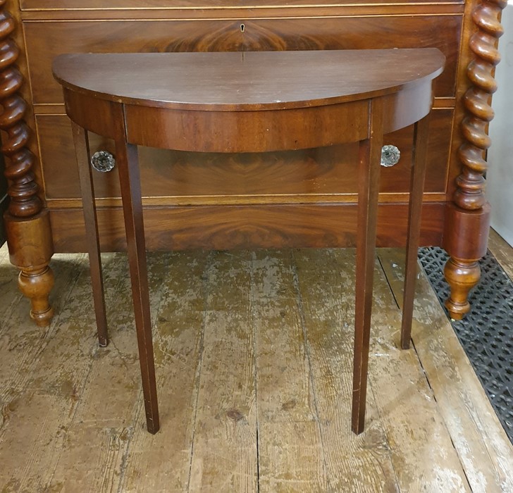 Late 19th/early 20th century mahogany side table of demi-lune form, on four square section