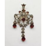 Edwardian-style, garnet, seedpearl and diamond pendant of scroll design, set with central garnet,