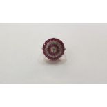 Platinum, diamond and ruby flowerhead design ring set with central old-cut diamond and further row