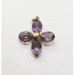 Gold coloured metal and amethyst coloured stone pendant, a quatrefoil set with four cut oval