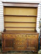 18th/19th century oak dresser with ogee moulded pediment above the three shelves, base of three