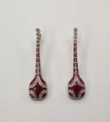 Pair of Art Deco style platinum, ruby and diamond pendant drop earrings, each with four collet set
