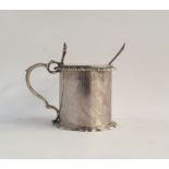 Silver circular mustard pot with hinged cover, blue glass liner, gadrooned border and spoon,
