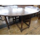 18th century oak gateleg dining table, the oval top with drop leaves, on base with turned