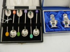 Set of six polychrome bean topped silver handled coffee spoons, Sheffield 1958, in case and a pair