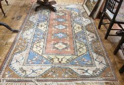 20th century peach ground carpet with five central diamond-shaped medallions, stepped border in