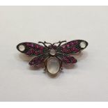 Silver coloured metal and gilt, ruby and moonstone butterfly brooch having four cabochon