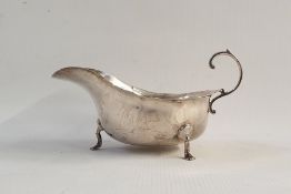 Silver sauceboat with cut card borders and scroll handle, on cabriole legs with pad feet, Chester
