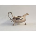 Silver sauceboat with cut card borders, scroll handle, raised on cabriole legs with pad feet,
