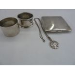 Two silver napkin rings, silver cigarette case, engine turned, and a silver St. Christopher