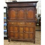 Antique oak duodarn cupboard with ogee moulded cornice, three panelled cupboard doors above a base