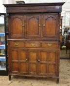 Antique oak duodarn cupboard with ogee moulded cornice, three panelled cupboard doors above a base