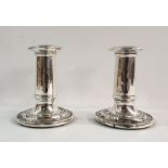 Pair of Victorian weighted silver candlesticks of plain column form, on circular stepped bases,