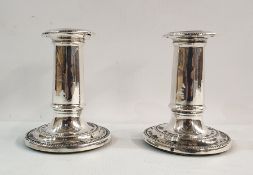 Pair of Victorian weighted silver candlesticks of plain column form, on circular stepped bases,