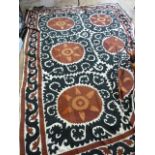 Indian Susani black and rust-coloured wool embroidered onto a cream linen ground, some fraying and