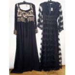 Jean Varon black lace evening dress over satin with net and lace bell sleeves, a deep V-neck, empire