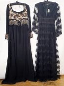 Jean Varon black lace evening dress over satin with net and lace bell sleeves, a deep V-neck, empire