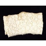 Early handmade tape-lace backed onto muslin, featuring floral decoration, possibly cut from a