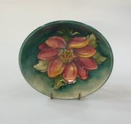 Moorcroft pottery dish, pink clematis decorated on mottled turquoise ground, 16cm diameter (with