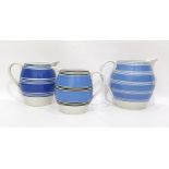 Three variously sized blue-banded jugs, ovoid (3)