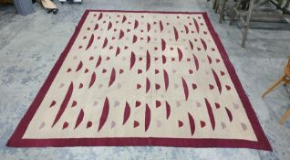 Modern cream ground rug with maroon decoration, 30