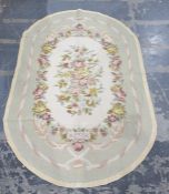 Tapestry rug with a pale celadon and ivory ground allover roses 176 cm X 115 cm