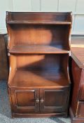 Waterfall bookcase finished in dark elm with two cupboard doors under